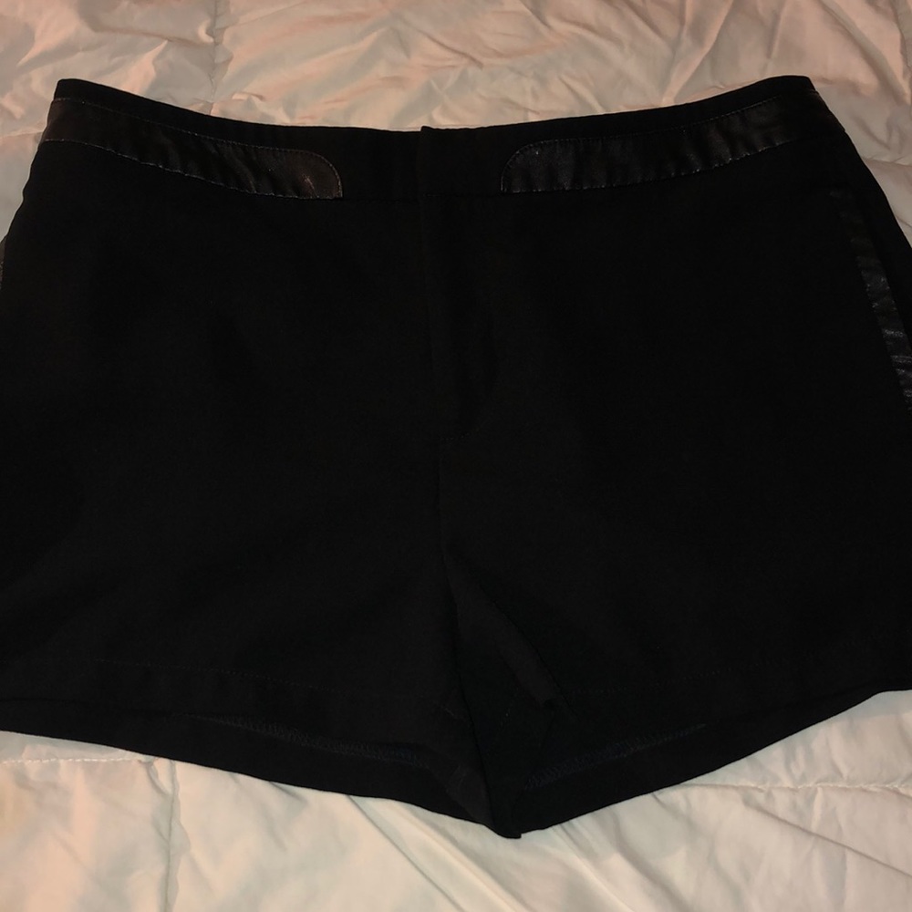 Black slack shorts with faux leather, pockets